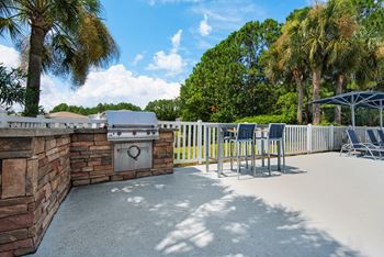 Outdoor grilling station with seating area.